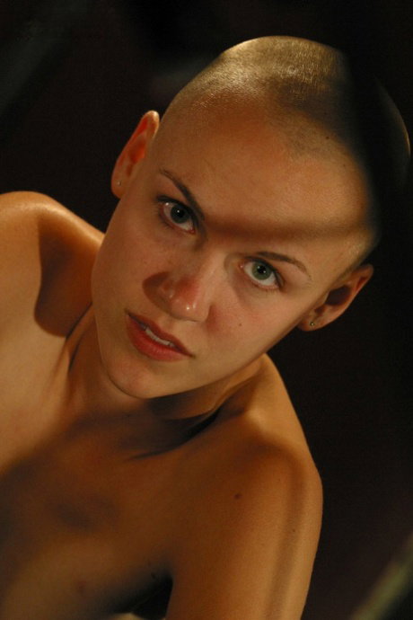 Young girl with a shaved head Karissa touches her shaved pussy in the nude