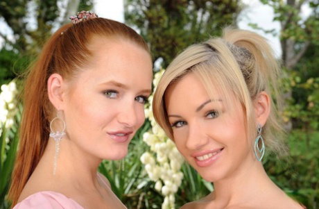 Lesbians Sasha Rose and Denisa Heaven have sex on a couch in the garden