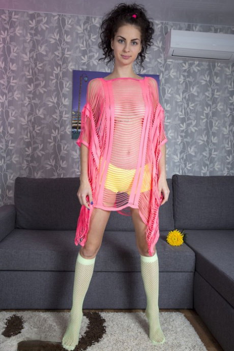 Skinny teen Kira removes see thru clothes to pose nude in mesh knee socks