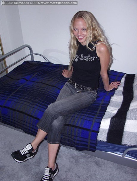Young looking blonde finger spreads her moist pussy after going nude