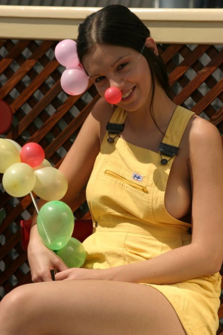 Beautiful girl Sweet Eva gets naked while blowing up balloons on a patio