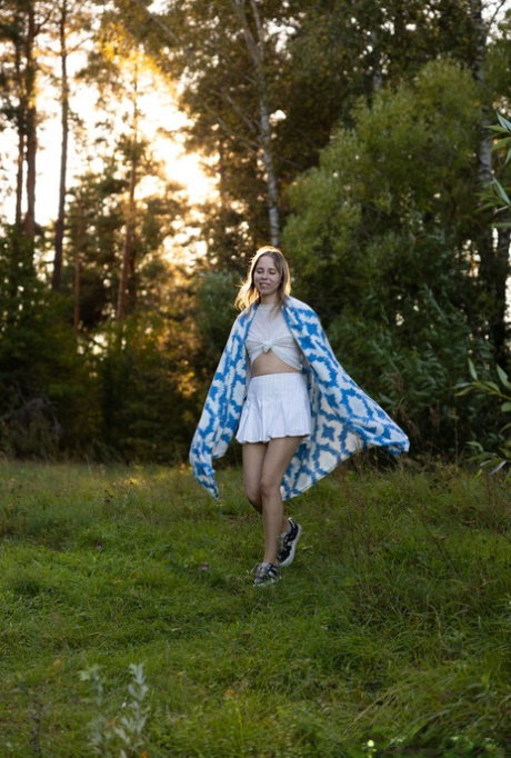 18-year-old girl Alice Murkovski strips to her sneakers near the water