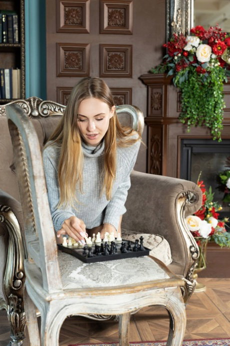 Young looking girl strips to her birthday suit on a chesterfield
