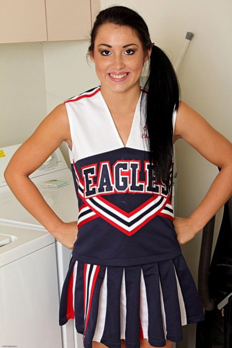 Young Latina girl Lola Foxx removes cheerleader attire during a SFW gig
