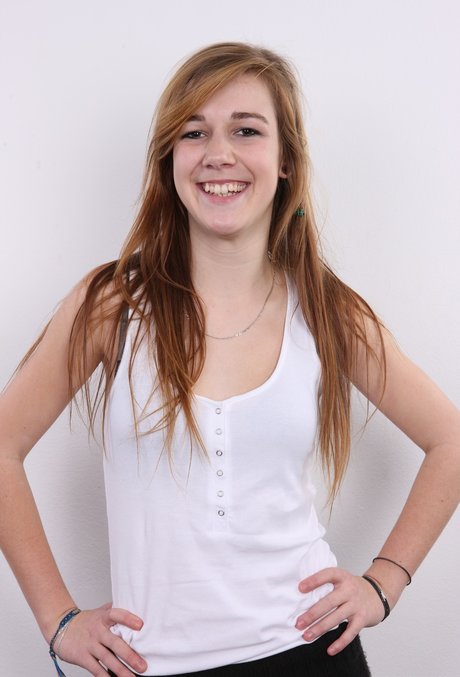 Young looking girl with long hair gets completely naked on a stool