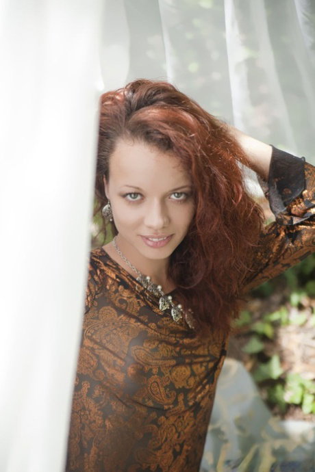 Natural redhead Korica A gets totally naked on a blanket in the woods