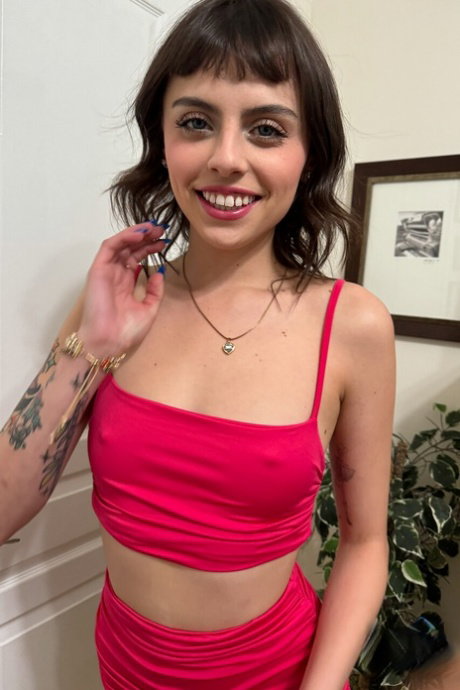 Amateur model Angel Windell strips off her red bikini while indoors