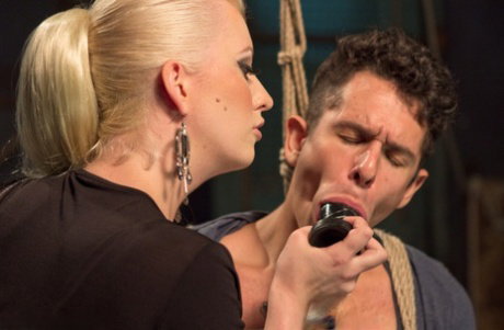 Cherry Torn has her way with a male submissive in a dungeon
