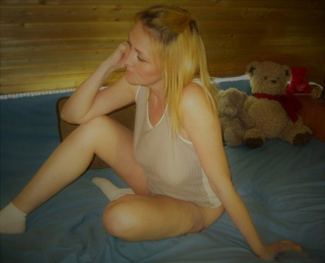 Mature blonde Lady La Perle removes her top & exposes her big natural tits