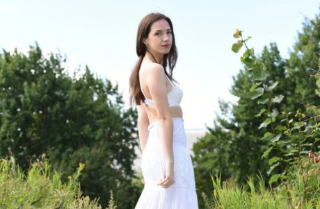 Brunette teen Dama gets completely naked as she heads down to the ocean