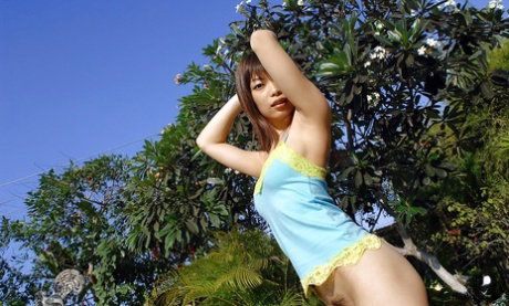 Asian coed Hikari Hino revealing her perfect bosoms and hairy pussy outdoor