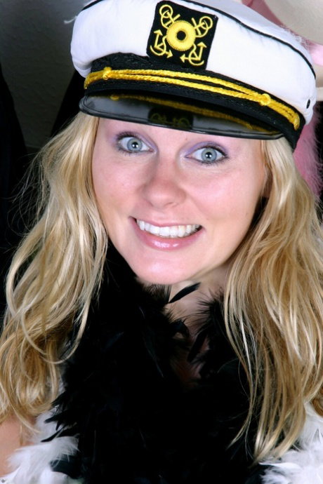 Busty blonde Ava Michelle wears a captain's hat while getting naked