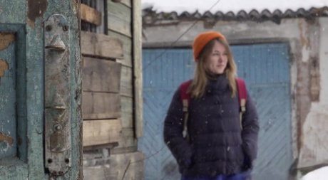 Cute girl pulls down jeans for an urgent piss on the steps of an old building