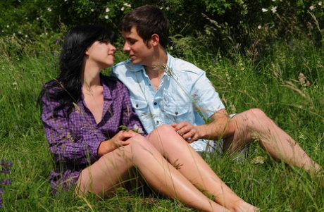 Dark haired teen and her boyfriend have sex in a grassy area