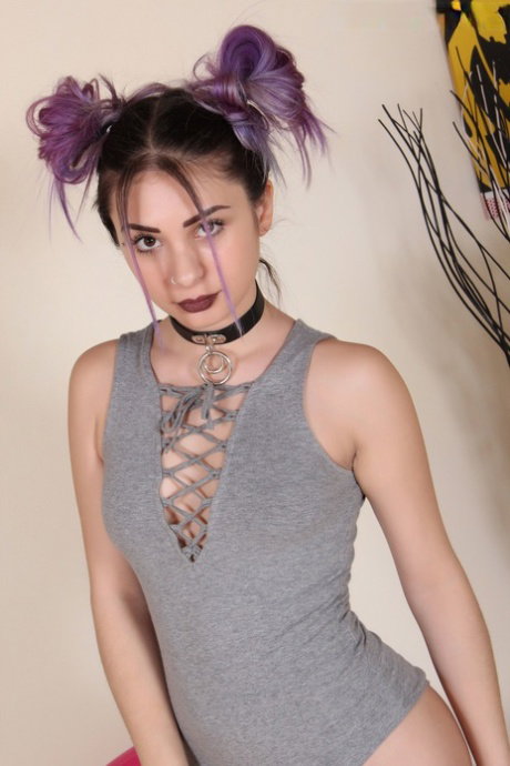 Clothed solo girl displays her bare feet and painted toes in pigtails