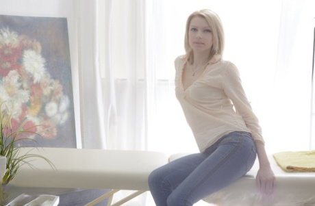 Blonde teen Karina Grand has sexual intercourse during a massage session