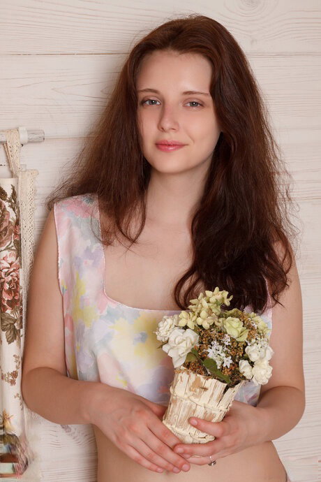 Sweet teen girl shows off her tight ass while getting mostly naked on a bed