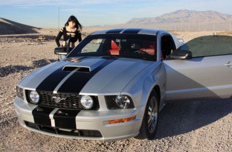 Brunette amateur Susy Rocks models by a muscle car during a safe for work gig