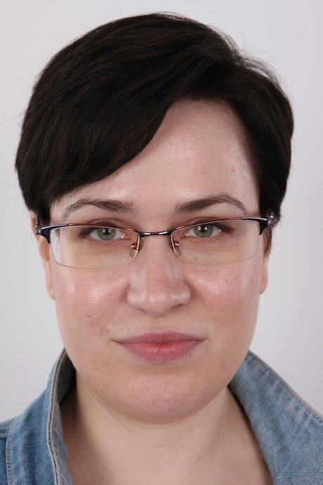 Overweight brunette gets completely naked while wearing her glasses
