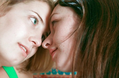Lesbians Carly T and Kara D share kiss before fingering each others pussy