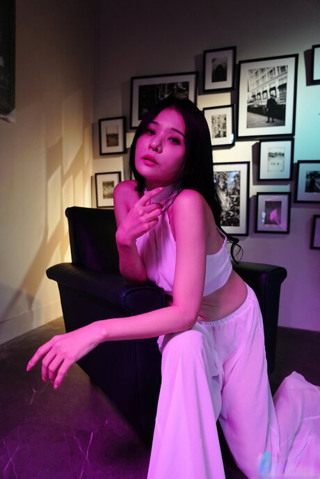 Chinese girl Xian Erai has sexual intercourse with her lover on a bed