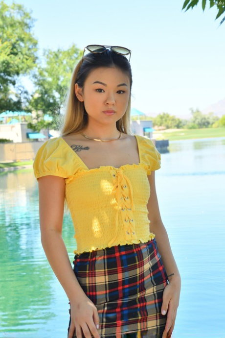 Tiny Asian babe Lulu strips naked in public and masturbates in her heels