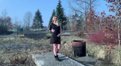 Blonde chick Claudia Macc squats for a piss on a concrete pad in black UGGs