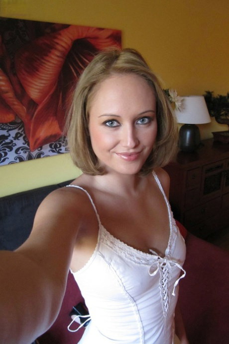 Middle-aged beauty removes her lingerie to set her perky boobs free