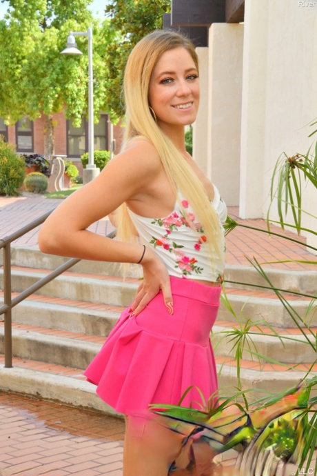 Amateur babe in a pink skirt River reveals her twat and poses in heels
