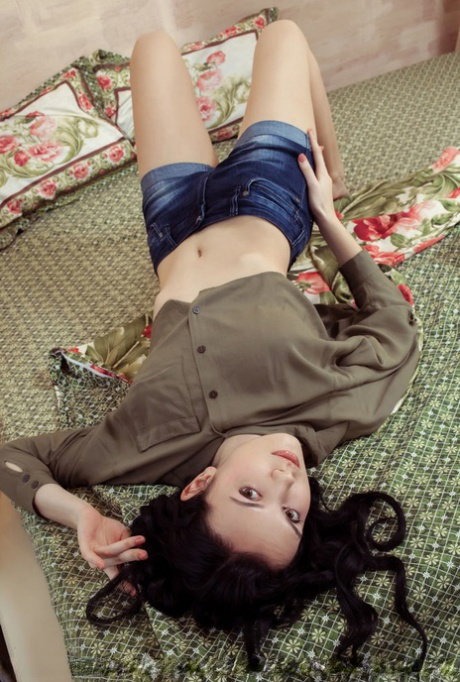 Dark haired beauty Anatali frees her beautiful body from clothes on her bed