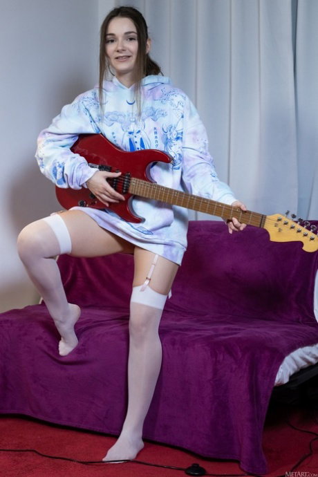 Cute teen undresses to play the electric guitar in white stockings