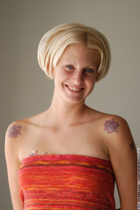 Blonde babe with tattoos Megan sticks four fingers in her twat & stretches it