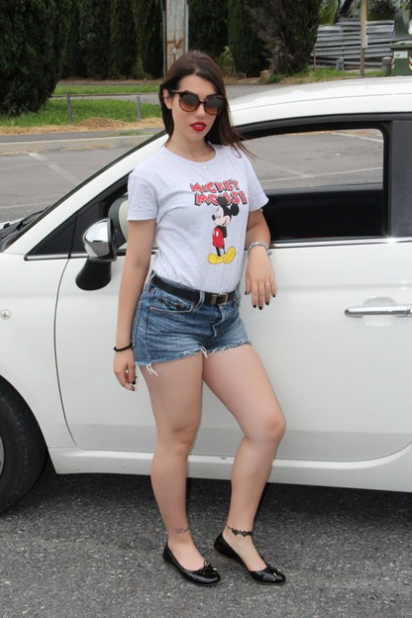 Clothed brunette Petra frees her pretty feet from flat shoes in driver's seat