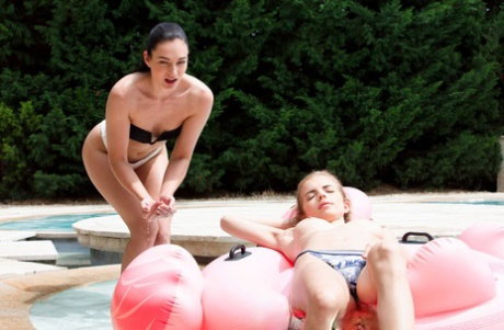 Young lesbians Emelie Crystal and Lee Anne lick each others pussy near a pool
