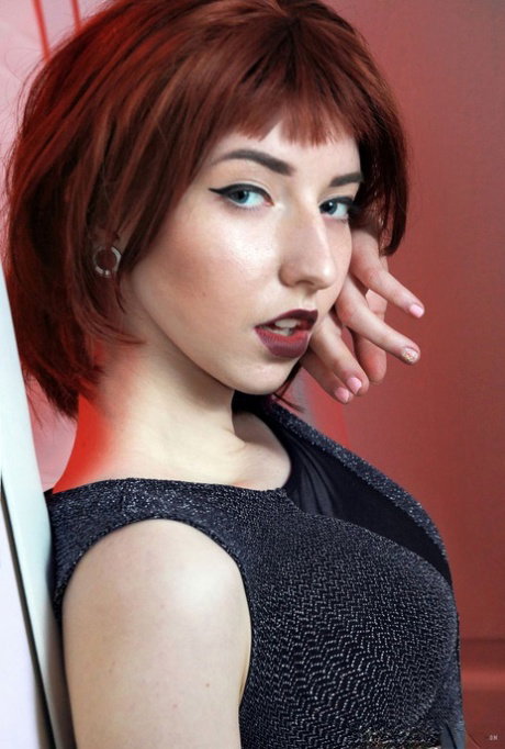 Redhead glam model strips to crotchless panties for pussy play