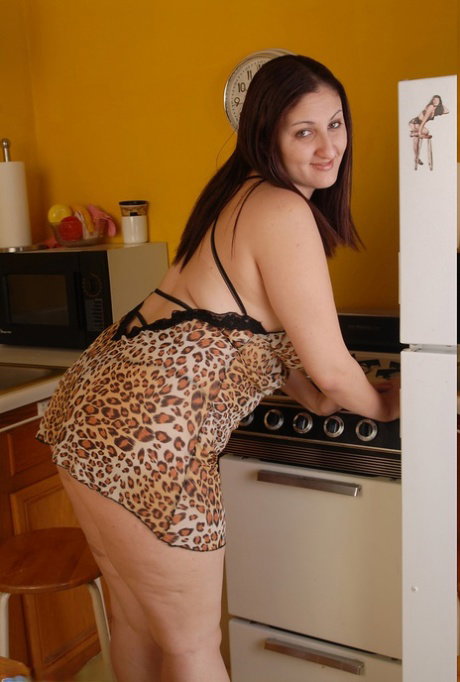Fat Latina Sonia strips in the kitchen, shows her big tits and rubs her twat