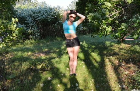 Brunette teen Shana Lane works her tits loose outdoors on a picnic table