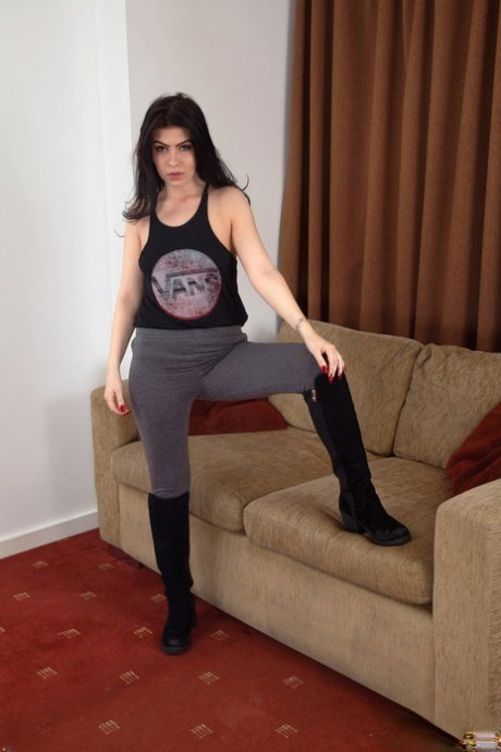 Alluring amateur brunette Lou Lou strips to show her hairy muff on a couch
