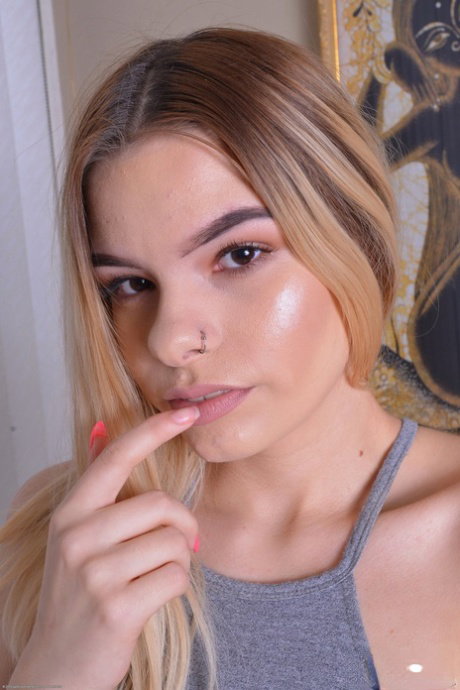 Fair skinned teen Cora Ora parts her tight pussy lips with her fingers