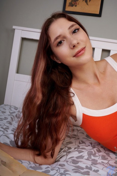 Nice teen Anasteysha Lee casts off her dress to pose nude upon her bed