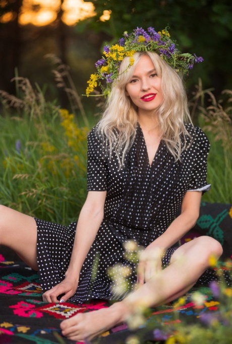 Solo girl in headband and red lips gets naked over a blanket in a meadow