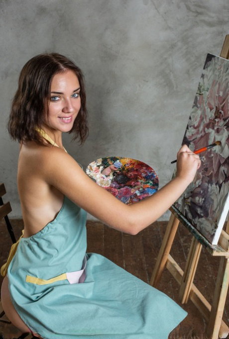 Nice teen Oxana Chic frees her tan lined body from painter's smock and panties