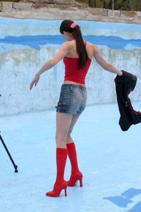 Sexy teen strips to red boots while using a camera on a tripod
