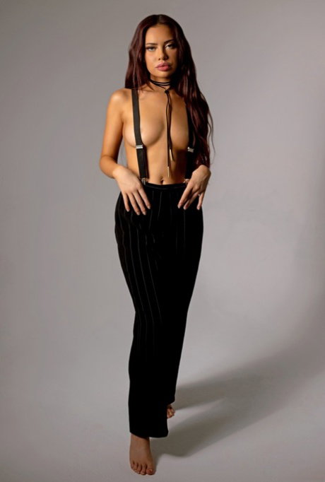Sexy redhead Sabina Rouge strips fully naked while flaunting her natural tits