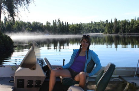 Young girl Andi Land unveils her small tits and pussy while on a boat