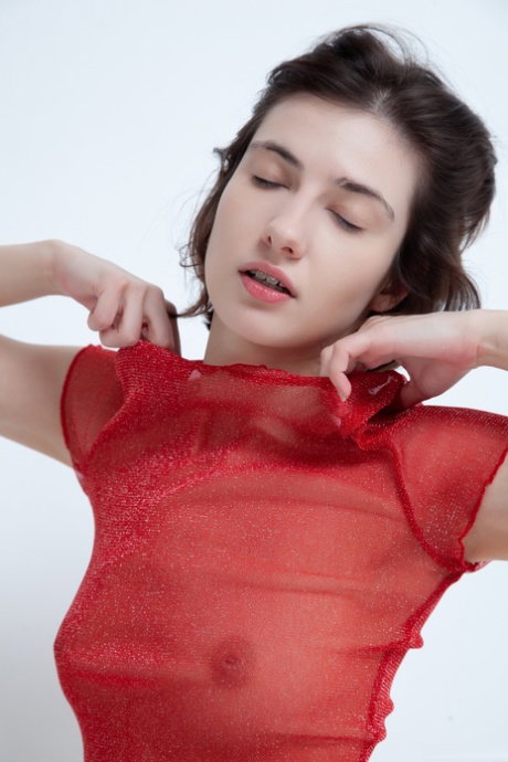 Solo girl with short hair exposes her tight ass and bald cunt in a red blouse
