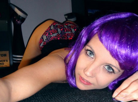 Cute teen Andi Land sports purple hair while taking semi-nude selfies