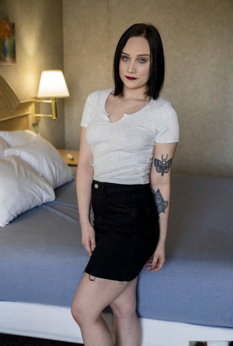 Sexy teen with tattoos Gwen Vicious strips and rubs her vagina on a bed