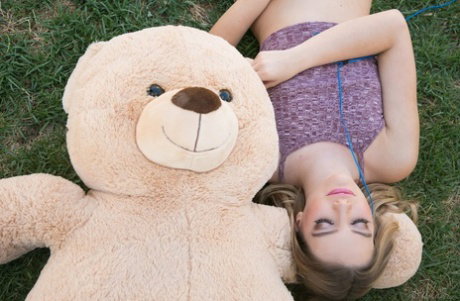 Clothed blonde teen takes her stuffed teddy bear with her wherever she goes