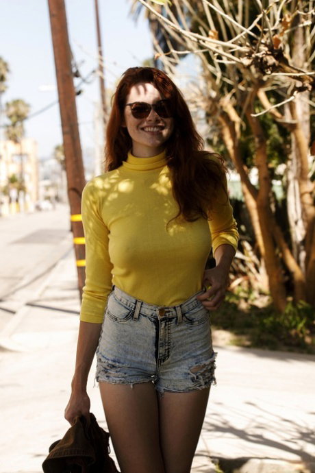 Babe Sabrina Lynn teases with her hard nips through a yellow sweater outdoors
